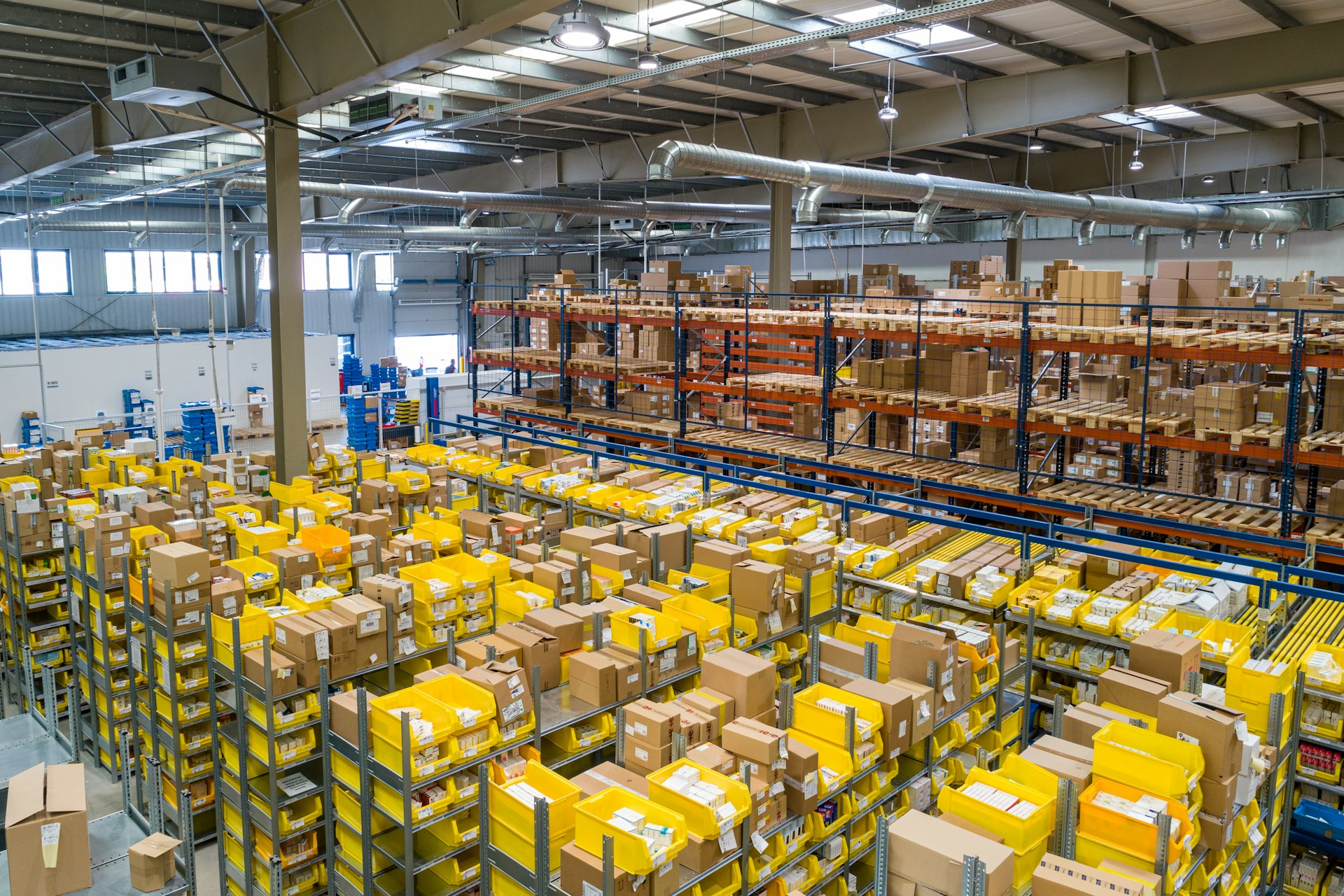 Modern warehouse with conveyor belts and blue trucks